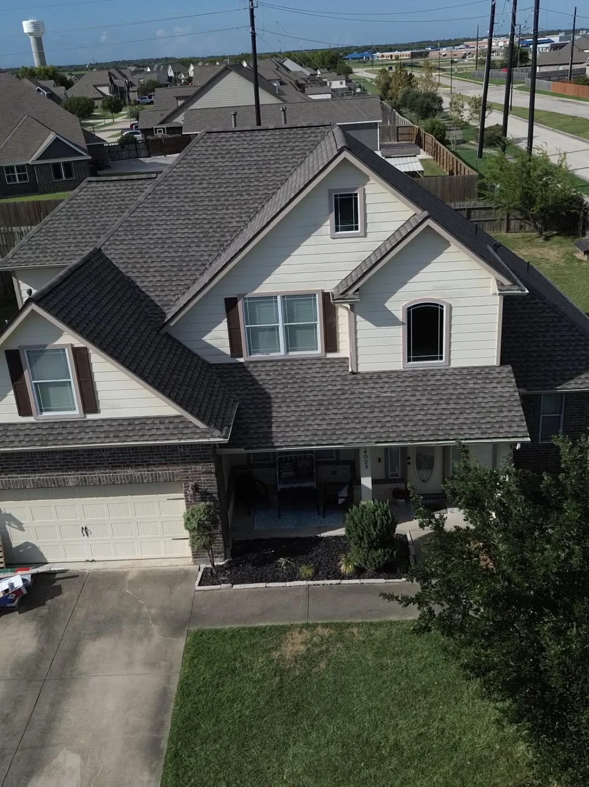 Front of a two-story home in Baytown, Texas, with siding, windows, and a garage door.
