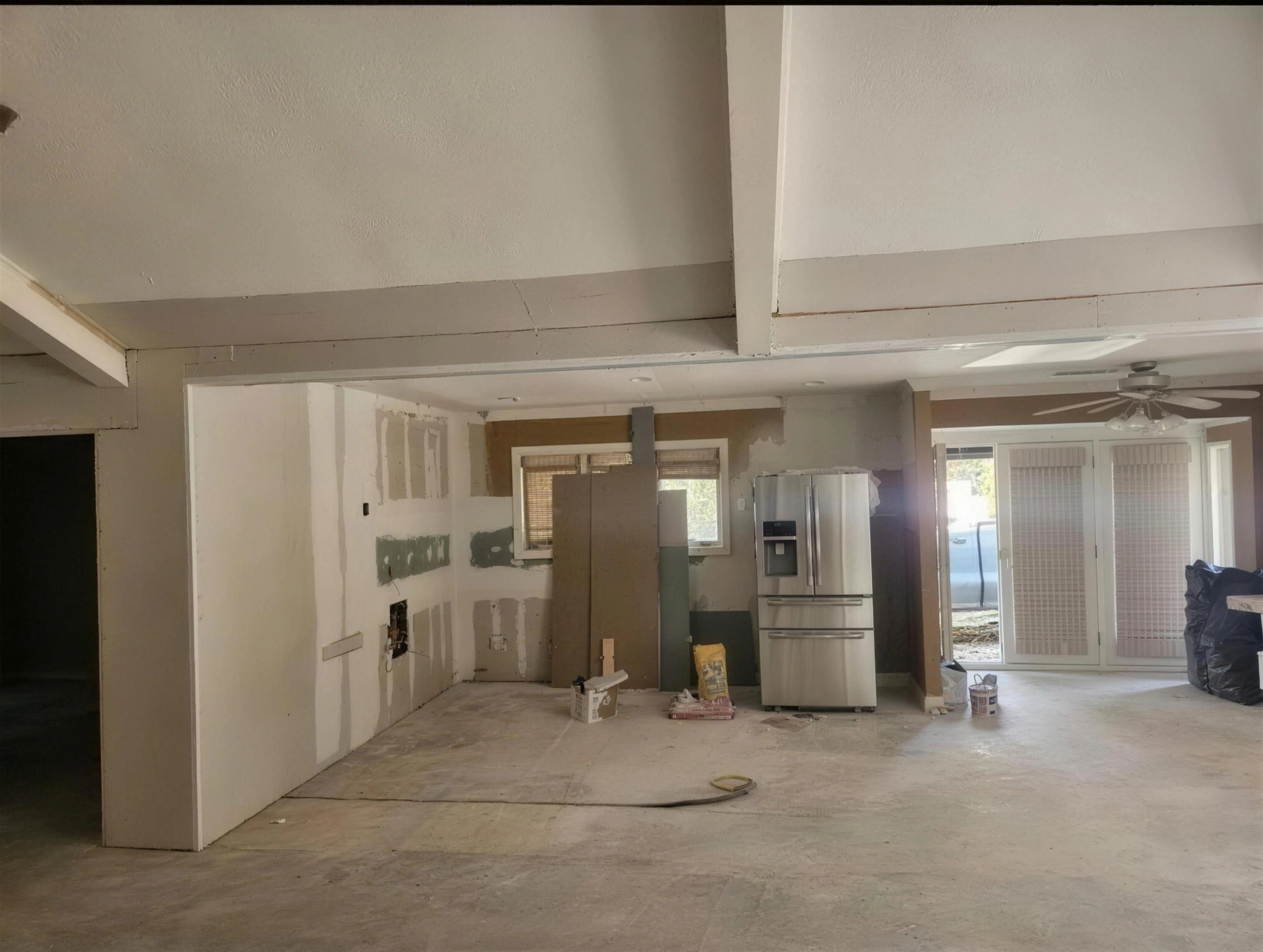 Kitchen with cabinets removed and exposed flooring before the renovation.