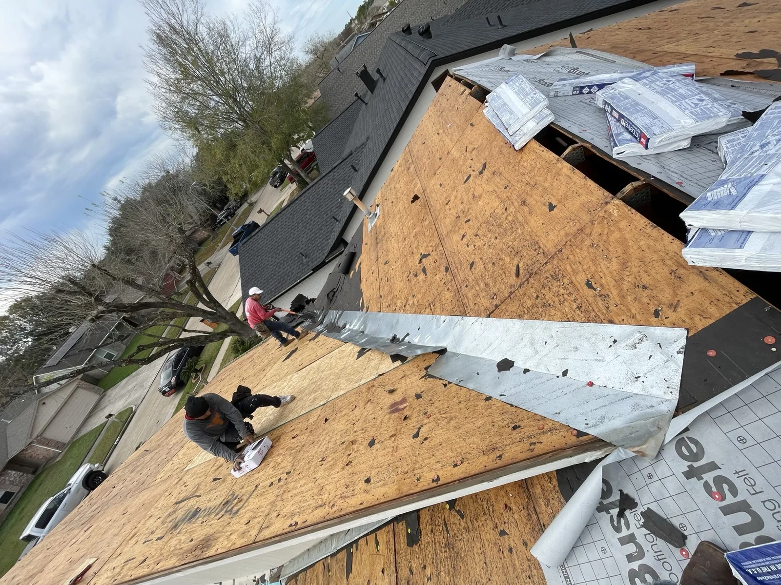 Roof decking and underlayment during a residential roof replacement.